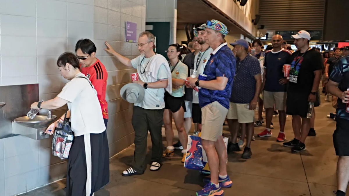 Soccer fans in Philadelphia Stadium line up for one of the water fountains ahead of the FIFA World Cup game between France and Paraguay on the Fourth of July. the region was under extreme heat conditions during the game