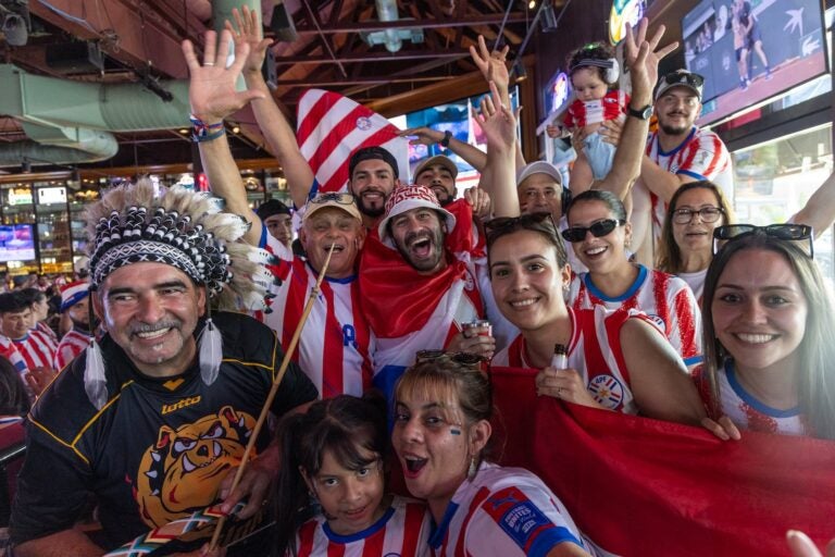 Paraguay fans cheer on their team during the game.
