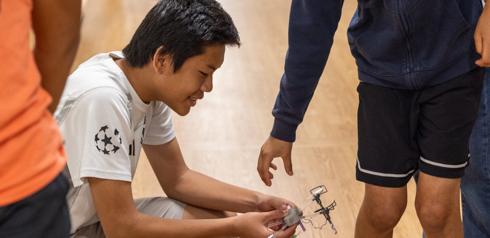 A child inspects the drone he built