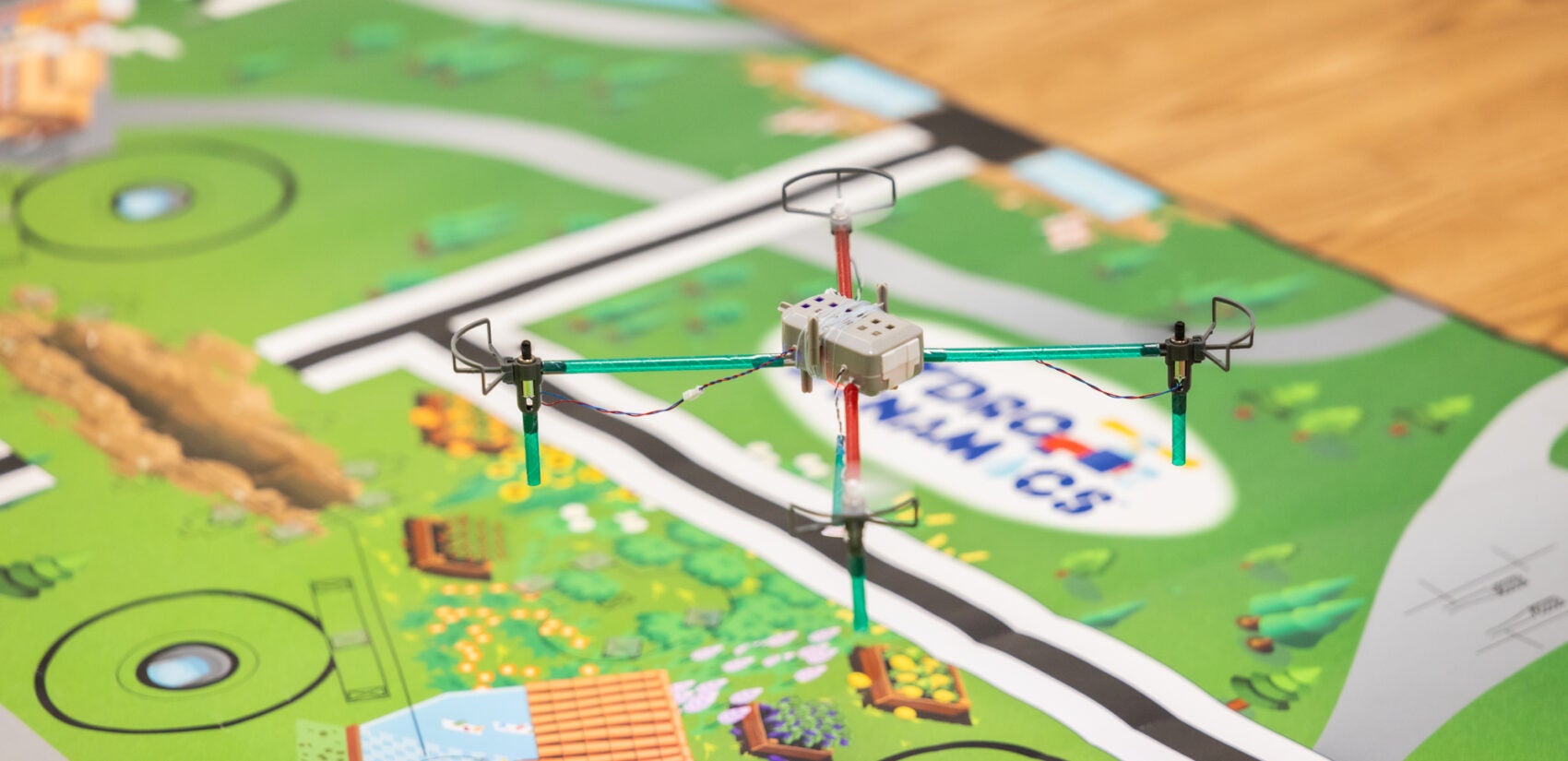 a small drone hovers over a table