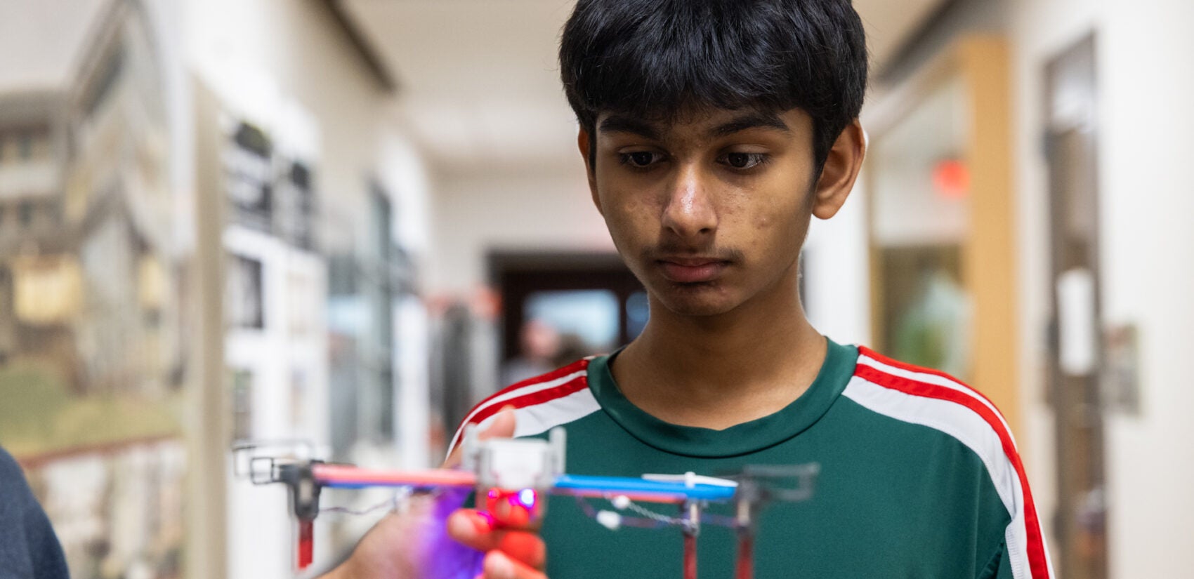 a child looks at a drone