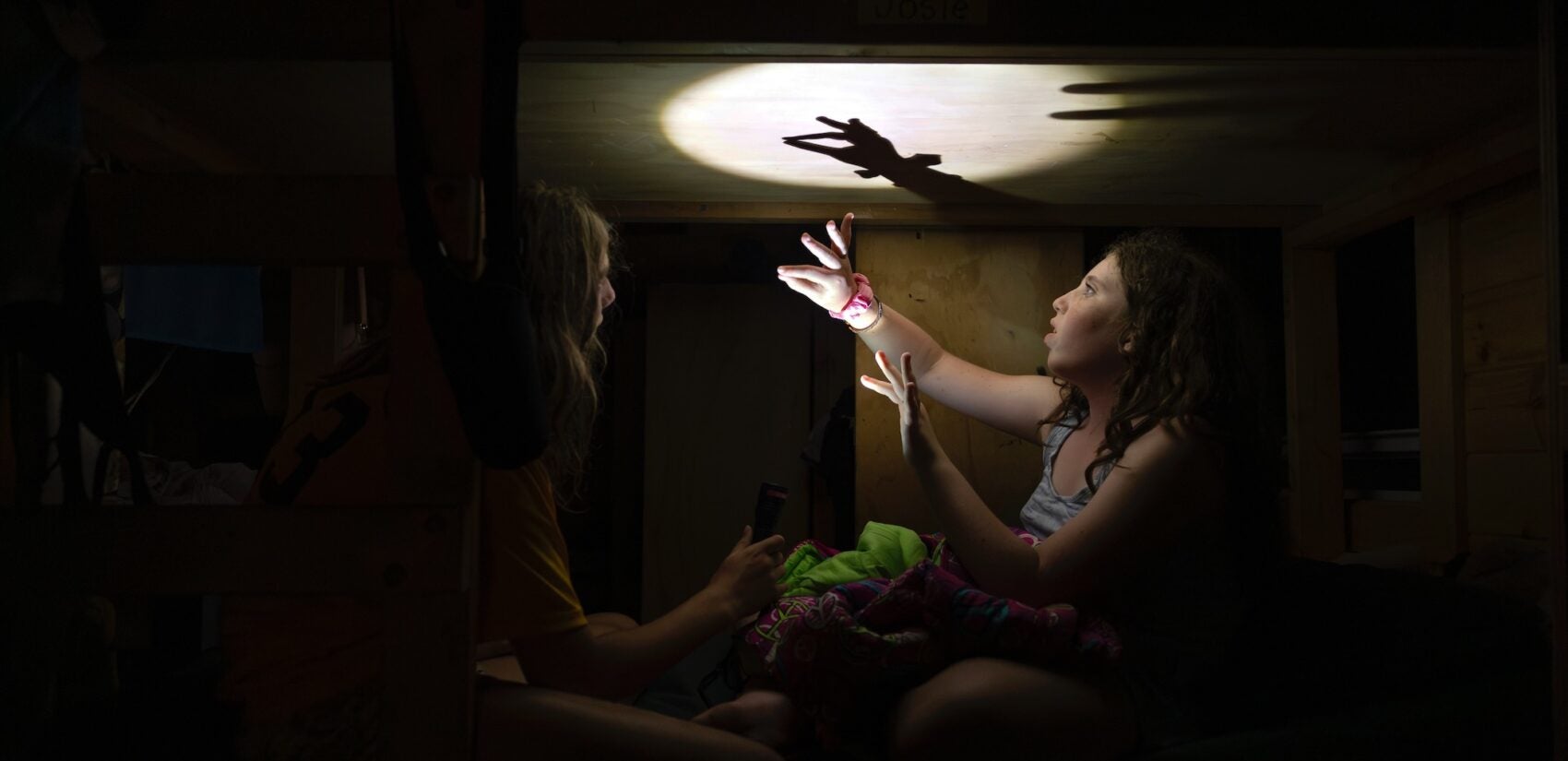 a camper performs a puppet show for another camper