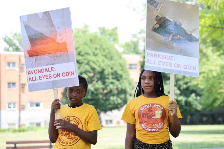 two children hold signs reading AVONDALE: ALL EYES ON ODIN and PARKEISDE: ALL EYES ON ODIN