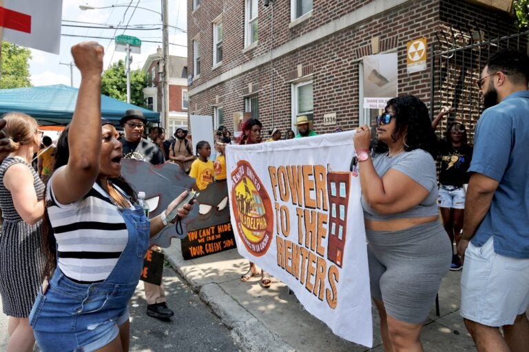 Renters march outside Avondale Apartments with a banner reading POWER TO THE RENTERS