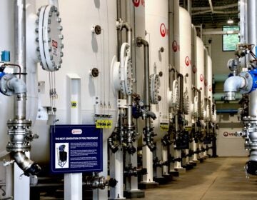 2025-06-18-e-lee-wilmington-del-stanton-water-treatment-plant-new-pfas-treatment-facility-tanks-and-sign-NU A line of tanks at a PFAS treatment plant in Stanton, Delaware