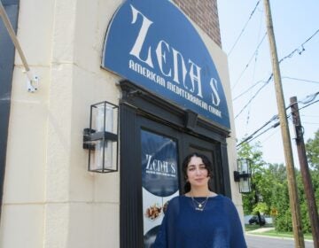 2026 08 12 k burns Zena Saifo at restaurant entrance-cropped Zena Saifo stands in front of the restaurant Zena's American Mediterranean Cuisine