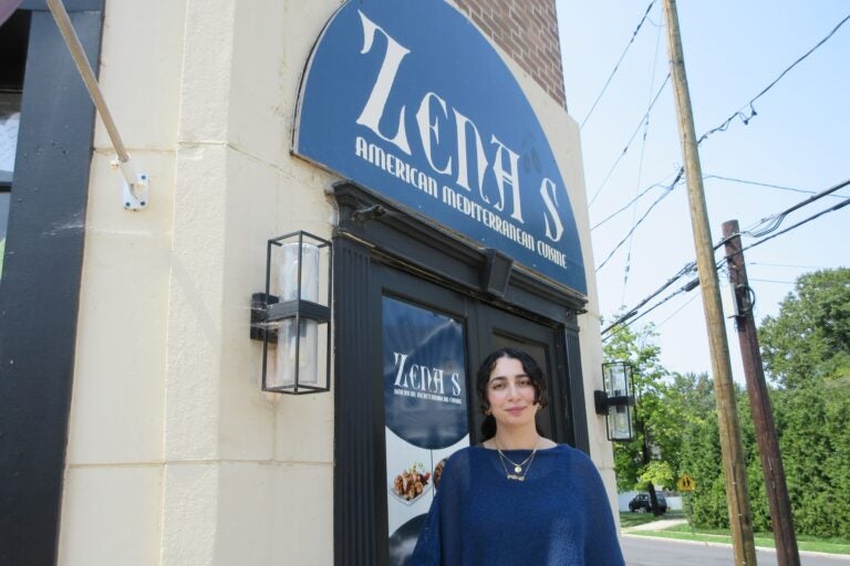 Zena Saifo stands in front of the restaurant Zena's American Mediterranean Cuisine