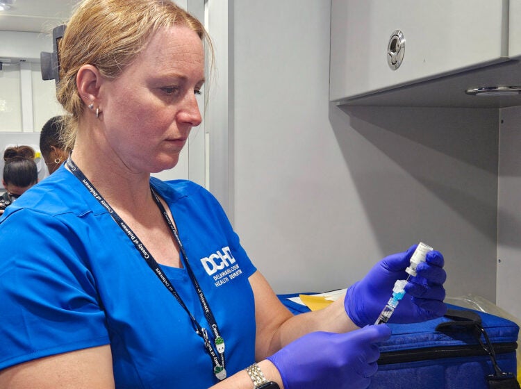 Registered nurse Diana Dur prepares a dose of a vaccine