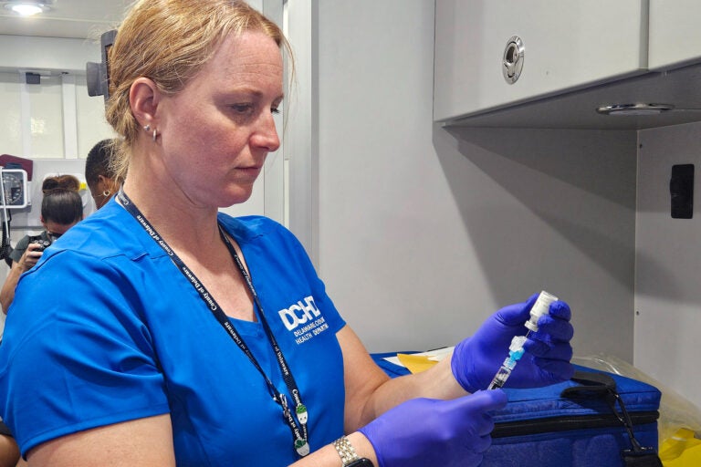 Registered nurse Diana Dur prepares a dose of a vaccine