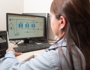 Freer_Water_Control_and_Improvement_District_-_Diana_Adame a worker looks at a computer to a water treatment facility