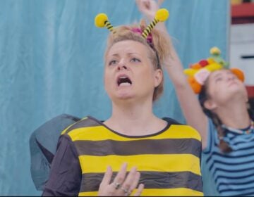 Screenshot Good Neighbor Club cast member dressed in bee costume.
