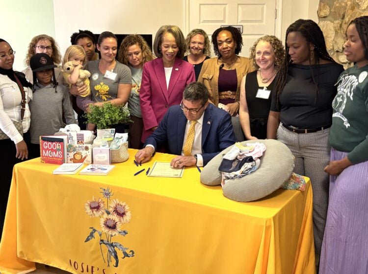 Meyer maternal health-2026 Matt Meyer signs legislation surrounded by standing women