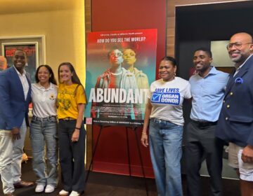 abundant-documentary-organ-donation People standing next to a poster for the documentary Abundant