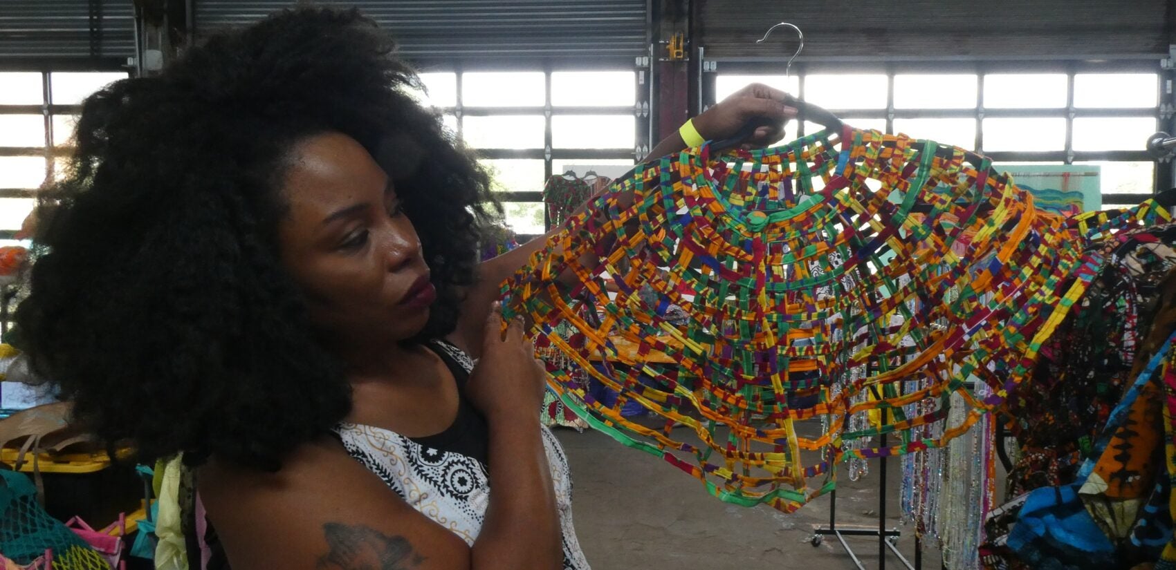 Rose Dousuah holding a clothing design