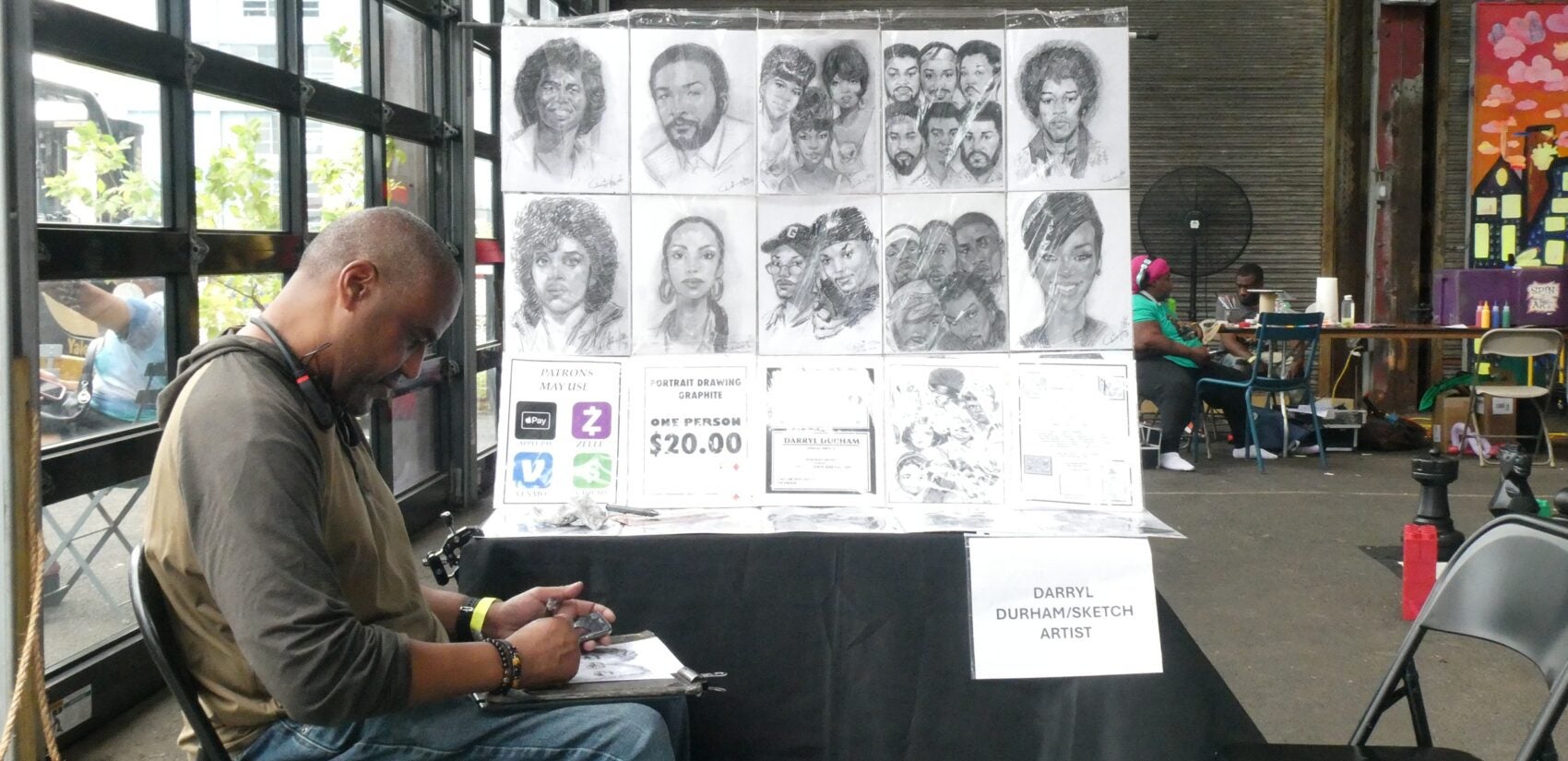 Sketch artist Darryl Durham at a table