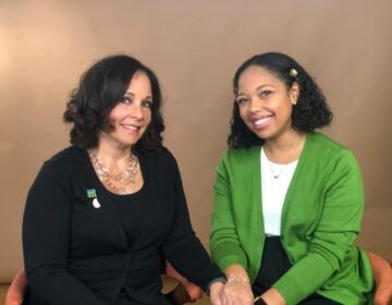 Sue Levy Giles and Alexandria Warner pose for a photo while sitting down