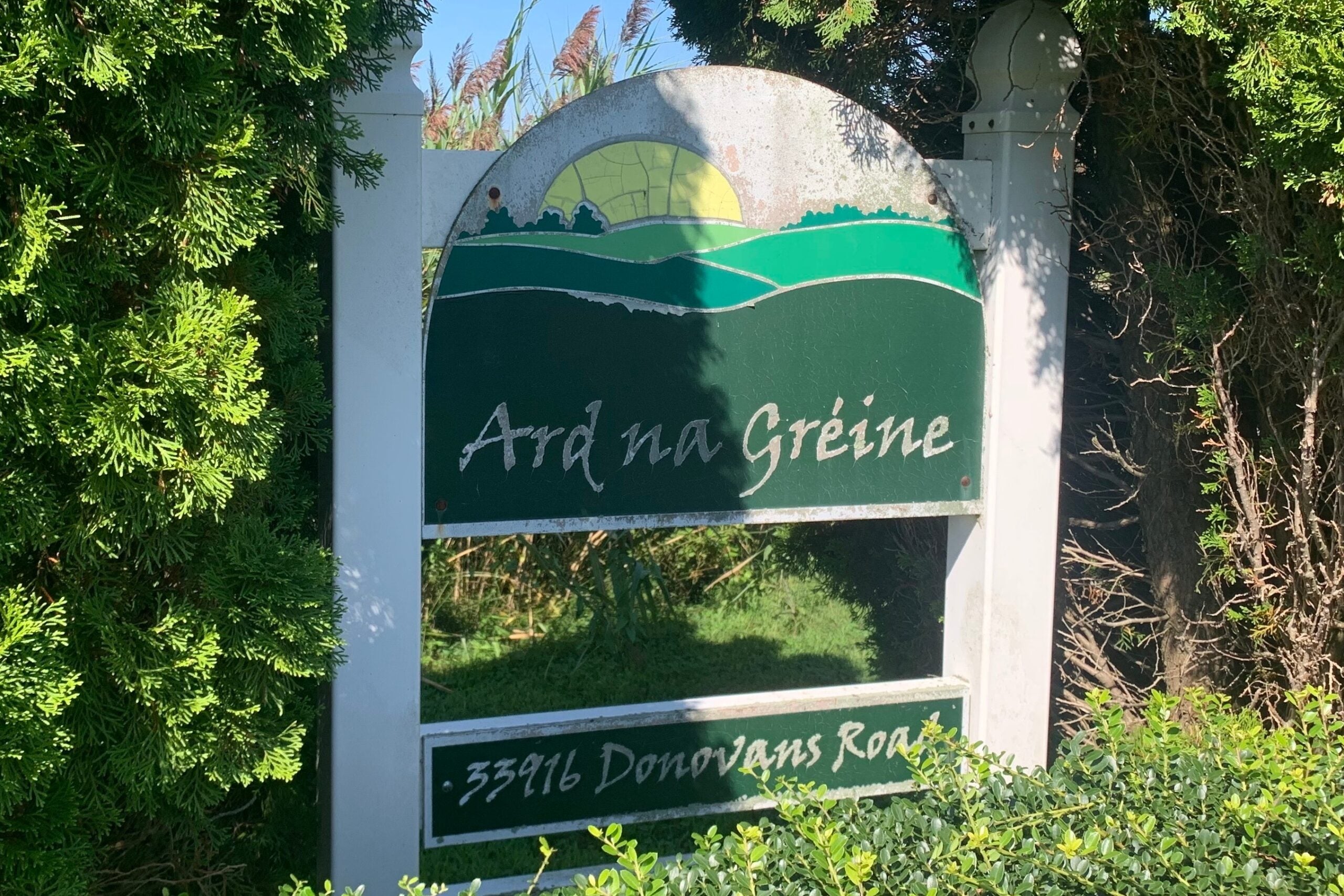 a sign reads Ard na Gréine 33916 Donovans Road