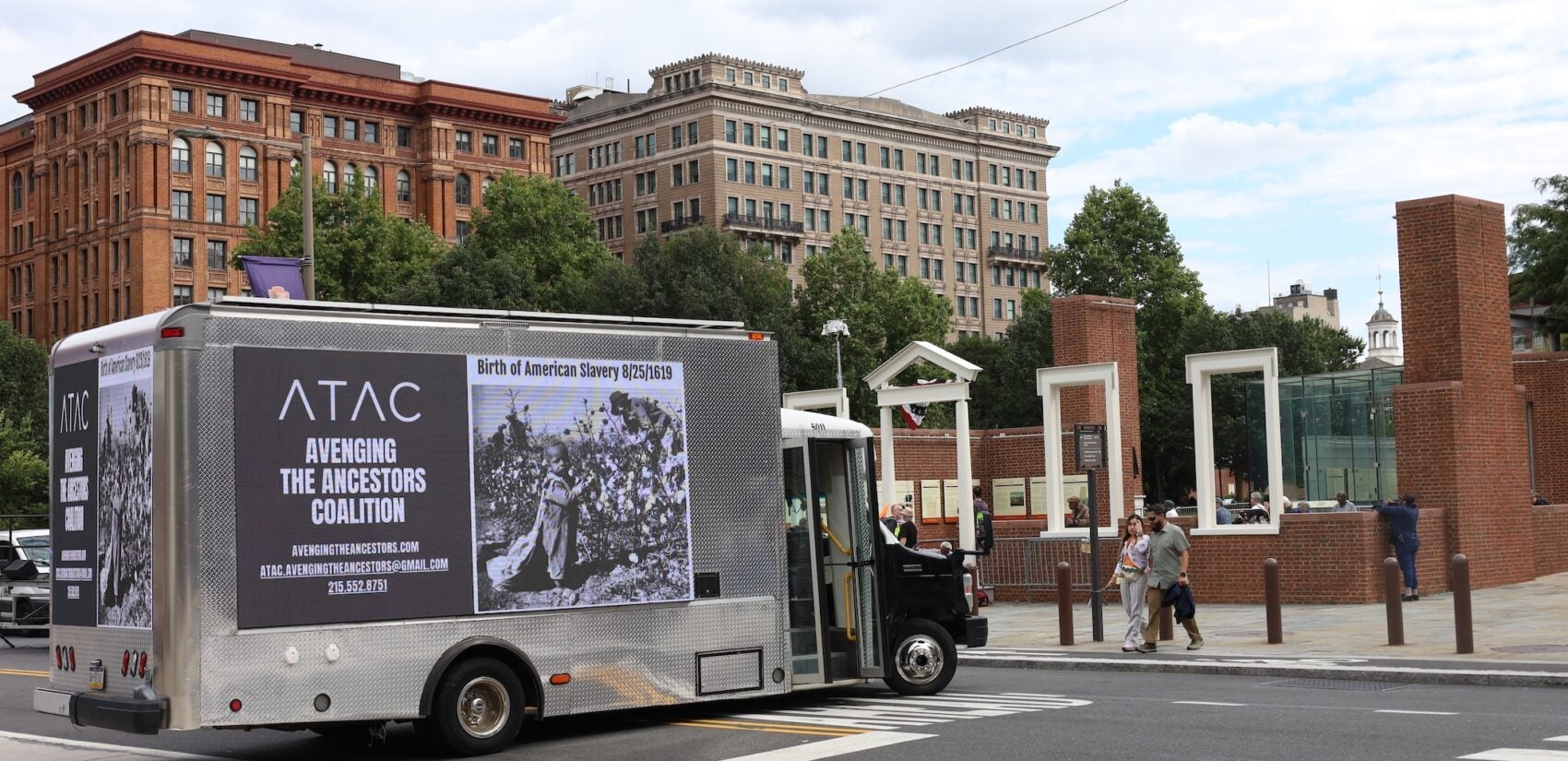A van covered in a large advertisement for Avenging the Ancestors Coalition sits parked on the street near Independence Mall, near the site of the President's House.