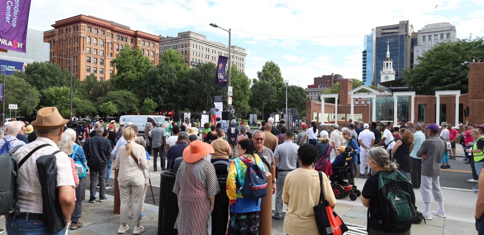 Many people are gathered on Independence Hall at the location of the President's House site.