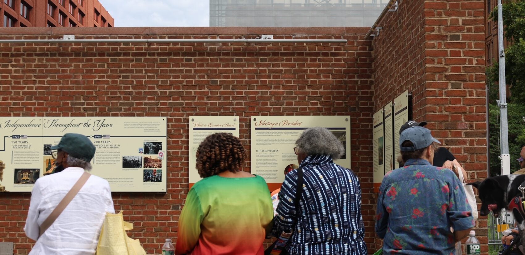 Many people are gathered on Independence Hall at the location of the President's House site.