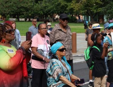 Many people are gathered on Independence Hall at the location of the President's House site.