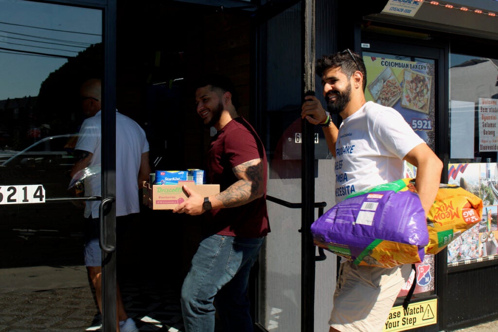 Men carry recovery packages meant for Colombia through a door