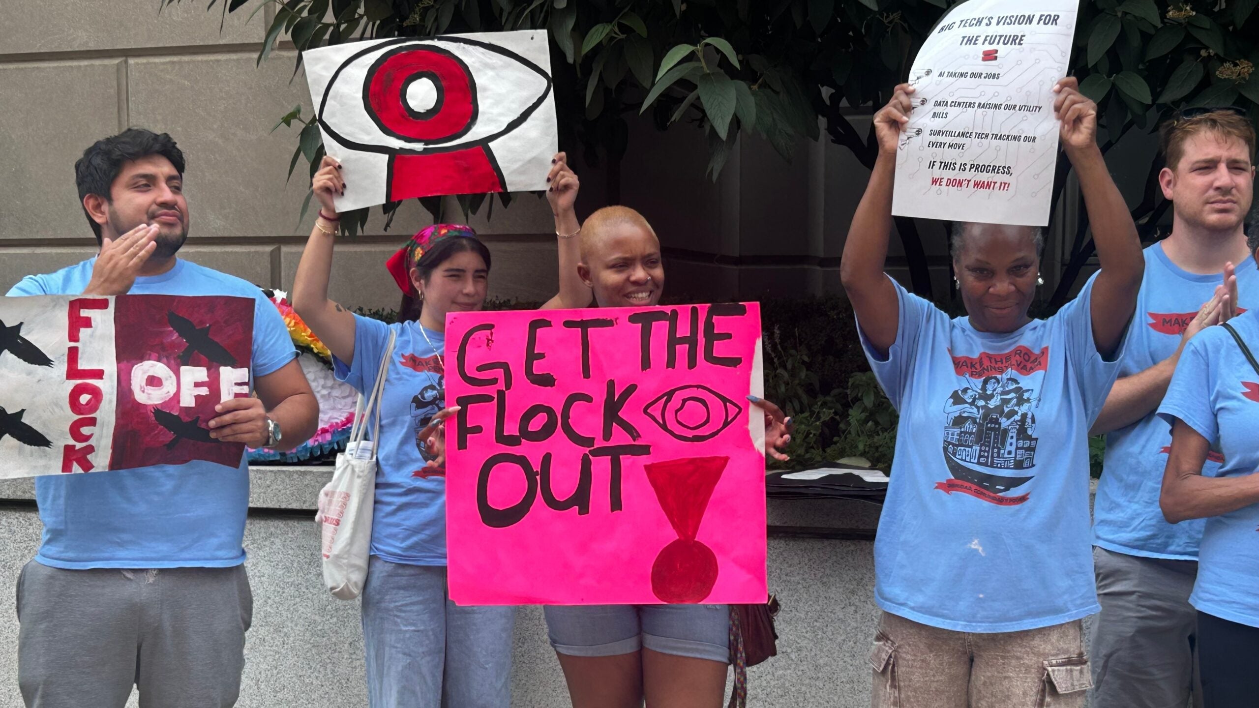 Protesters hold signs that read FLOCK OFF and GET THE FLOCK OUT, among others