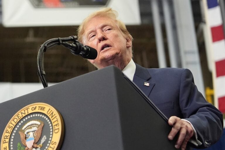 President Donald Trump speaks from behind a podium Friday, Aug. 28, 2026, at Johnson Space Center in Houston.