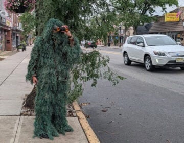 dunellen-police-department-shrub-undercover A Dunellen Police Department officer dressed as a shrub holding binoculars