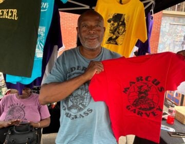 freedom-now-festival-2026-08-02-1 Sean Ramon Montague holds a Marcus Garvey shirt he made