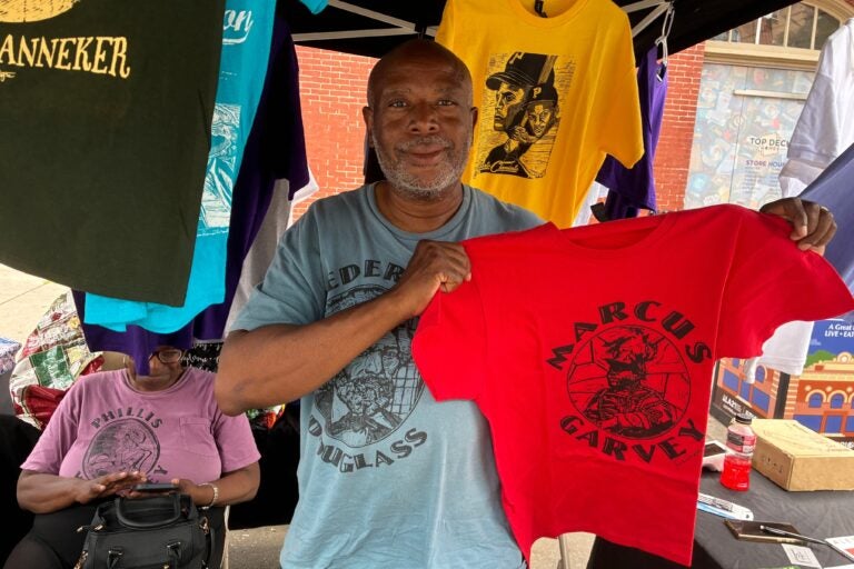 Sean Ramon Montague holds a Marcus Garvey shirt he made