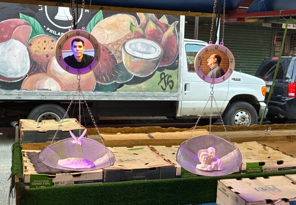pictures of community members made into parts of a weighing scale for food