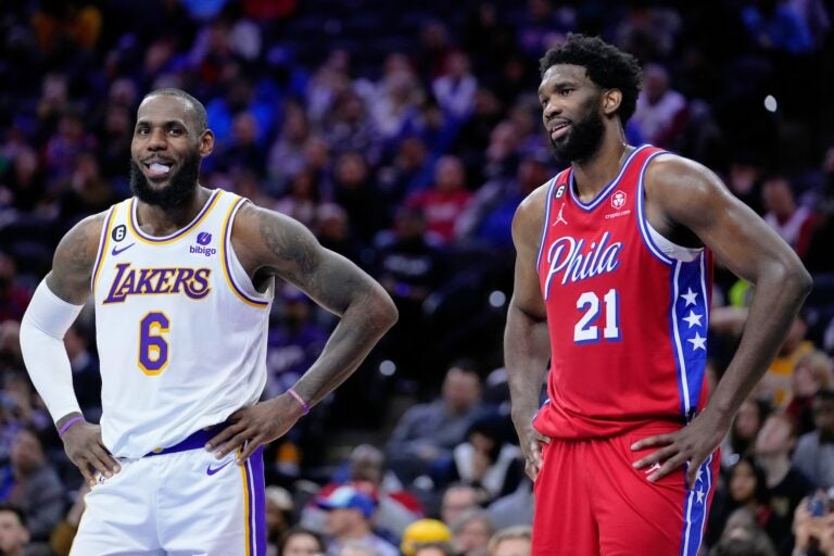 Los Angeles Lakers' LeBron James and Philadelphia 76ers' Joel Embiid play