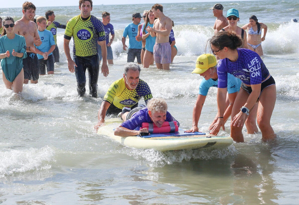 a person is helped to surf