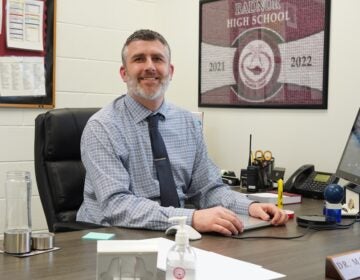 Joe MacNamara is sitting at his desk inside his office at Radnor High School.