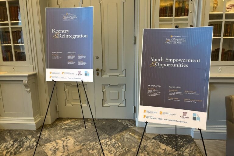 two signs read REENTRY & REINTERGRATION and YOUTH EMPOWERMENT & OPPORTUNITIES