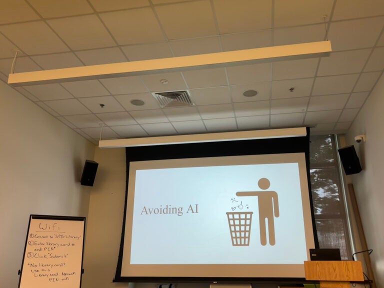 A projector shows a slide that reads 