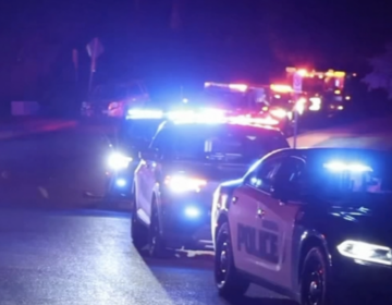 Pottsgrove police cars with their sirens on at night.