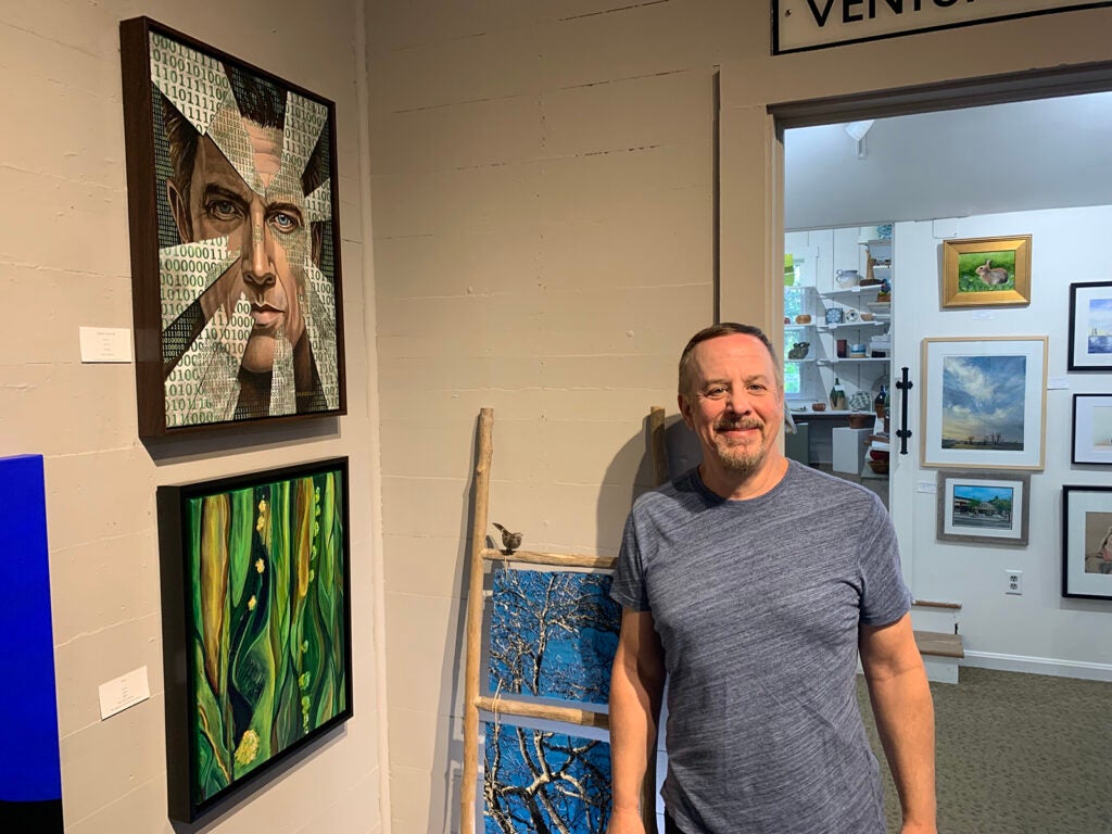 Joe Barbella stands next to his art piece "System Overdrive"