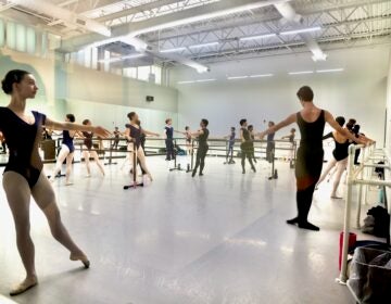 2026 09 03-e lee-philadelphia ballet-new building sneak peak school studio reflections In a large open room, many ballet dancers are rehearsing.