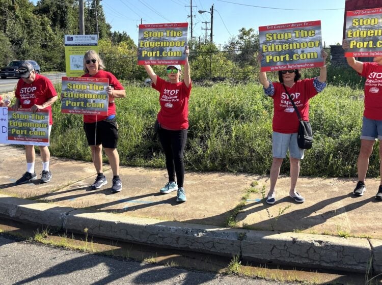 Edgemoor protesters-2026-09-14 Nearby residents of the Edgemoor site wearing matching red t shirts hold up signs protesting the development site.