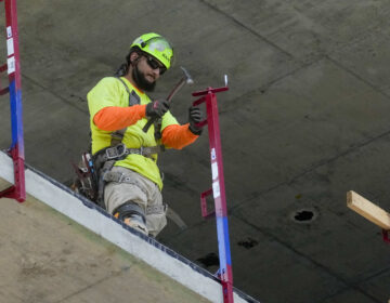 Job Openings A construction worker installs a safety railing on a new building in Philadelphia