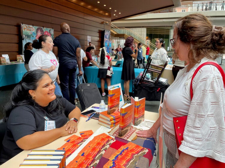 philadelphia-latin-american-book-fair-2026-1 A book author speaks speaks to a woman at a book fair