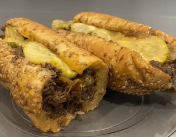 A cheesesteak with pickles