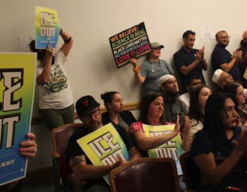 upper-darby-ice-legislation-2 Residents holding signs reading ''ICE out of Upper Darby' clap as an ordinance is passed by Township Council that limits collaboration with U.S. Immigration and Customs Enforcement