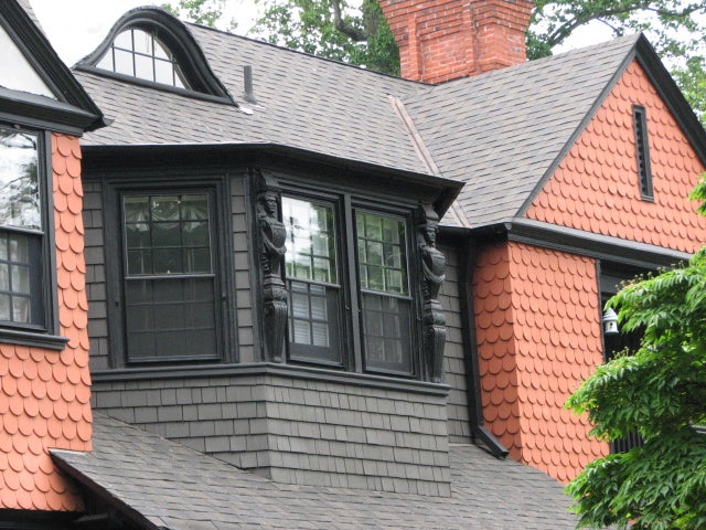 A decorative bay window breaks up the plane on the third level.