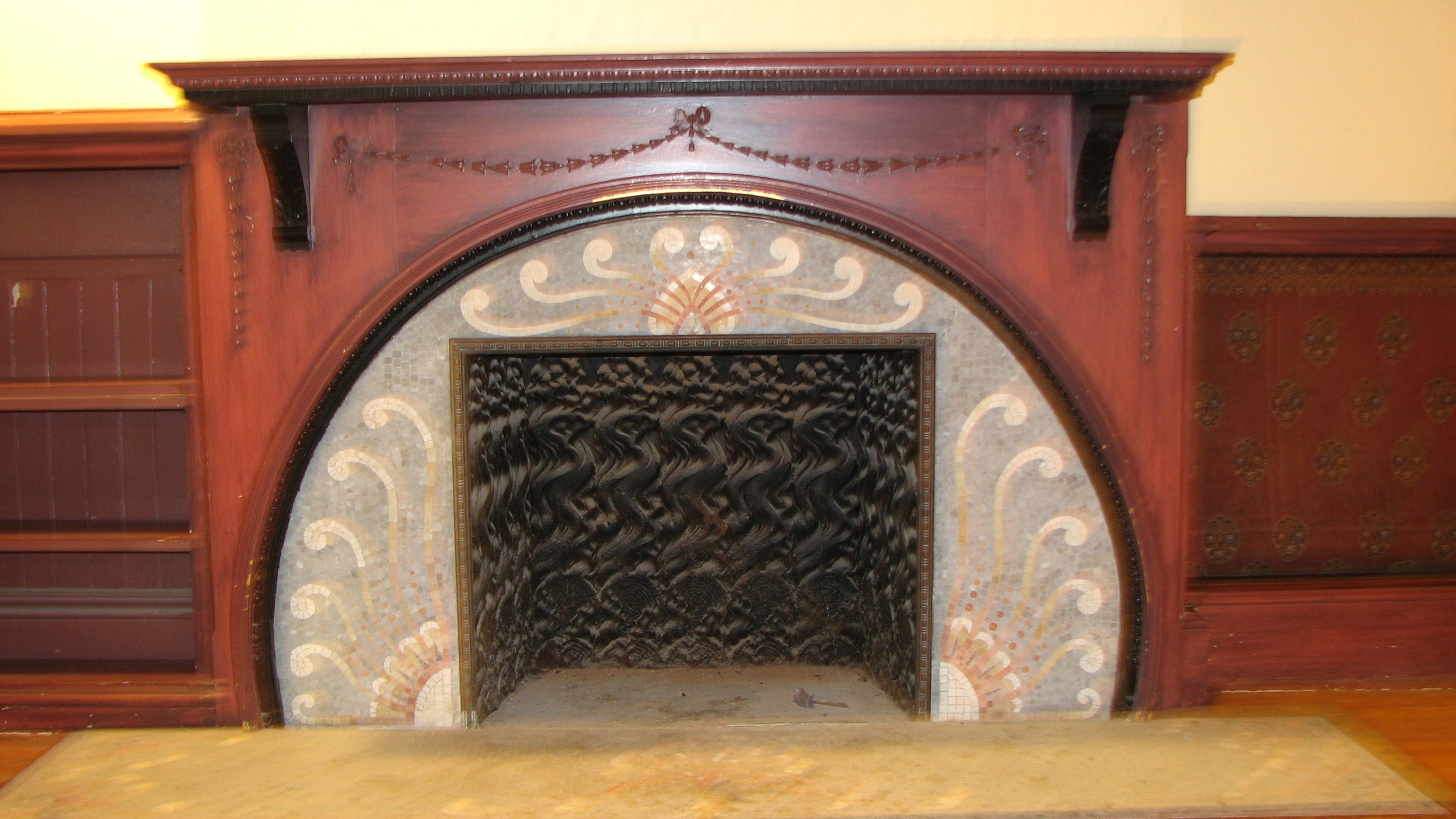 The house has unique fireplaces, including a beautiful mosaic hearth in the former ballroom.