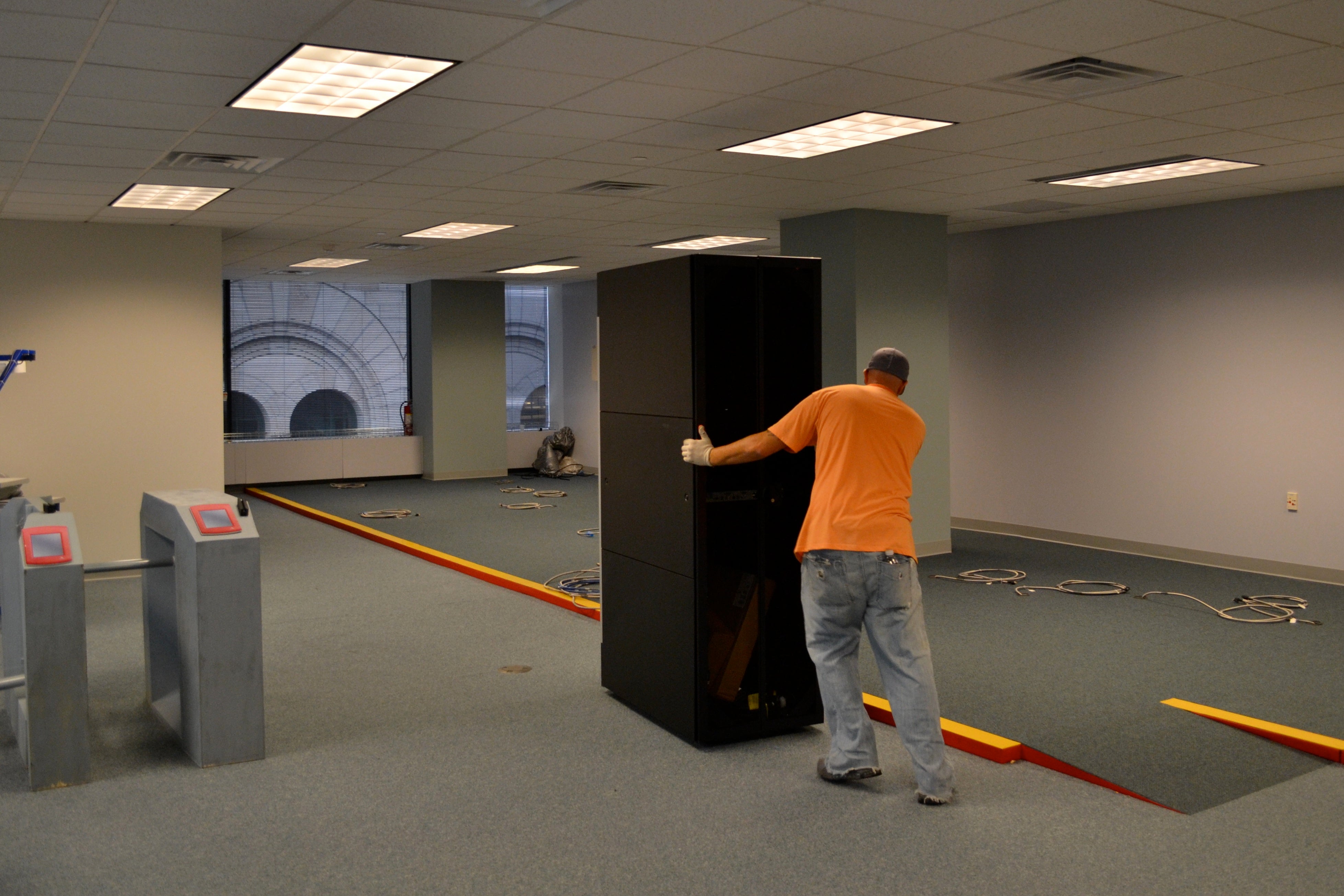 Crews moved two racks that will store the back end computer systems into the room SEPTA is turning into an NPT test facility