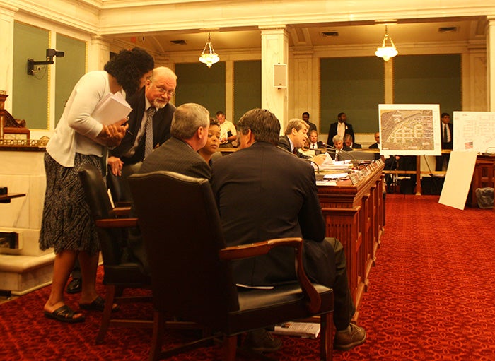 Council members huddle, finalizing amendments to zoning code bill