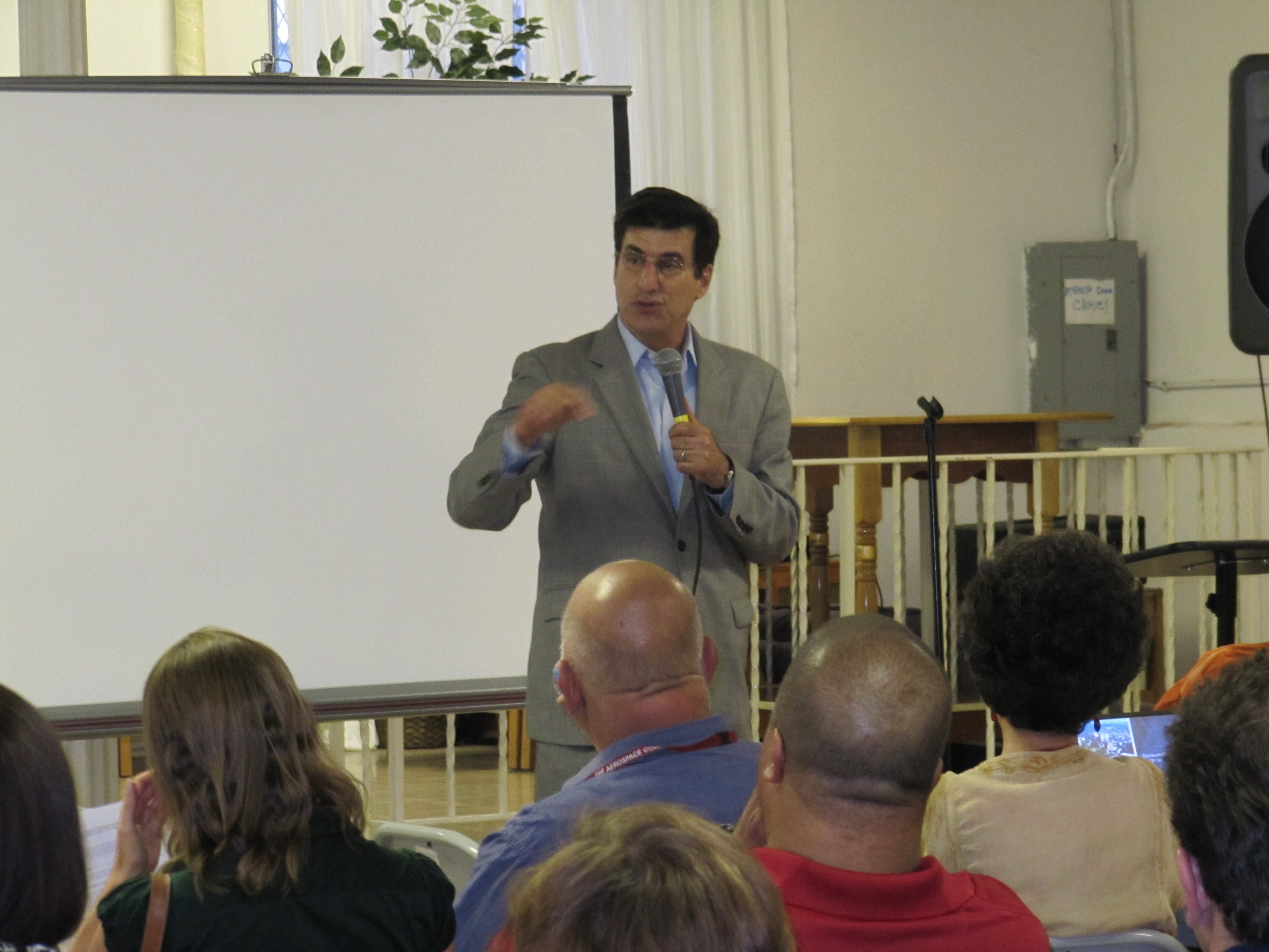 Michael DiBerardinis, Commissioner of Parks and Recreation, welcomes the crowd to Francisville